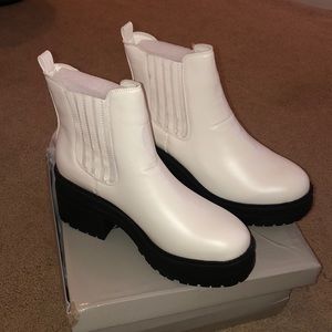 Short white platformed boots.